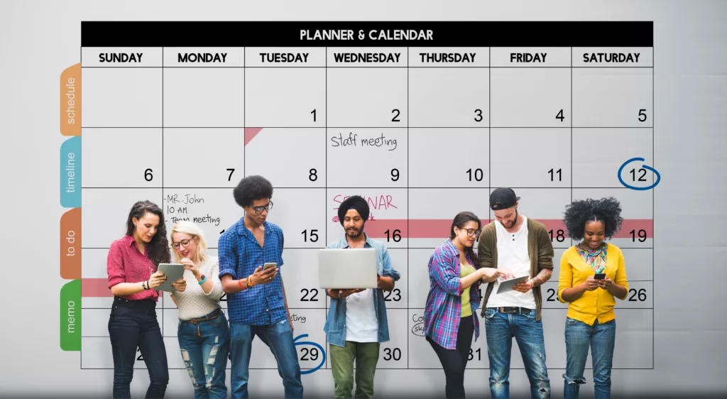 des collègues devant un calendrier